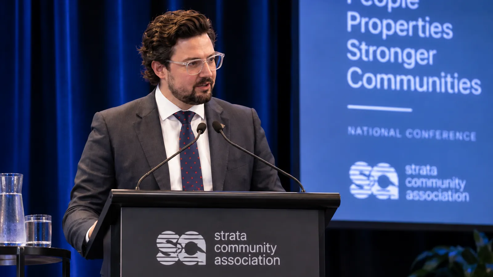 Joshua Baldwin presenting on stage at a conference