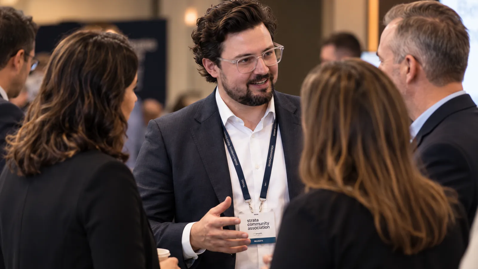 Joshua Baldwin in conversation with colleagues at an industry event