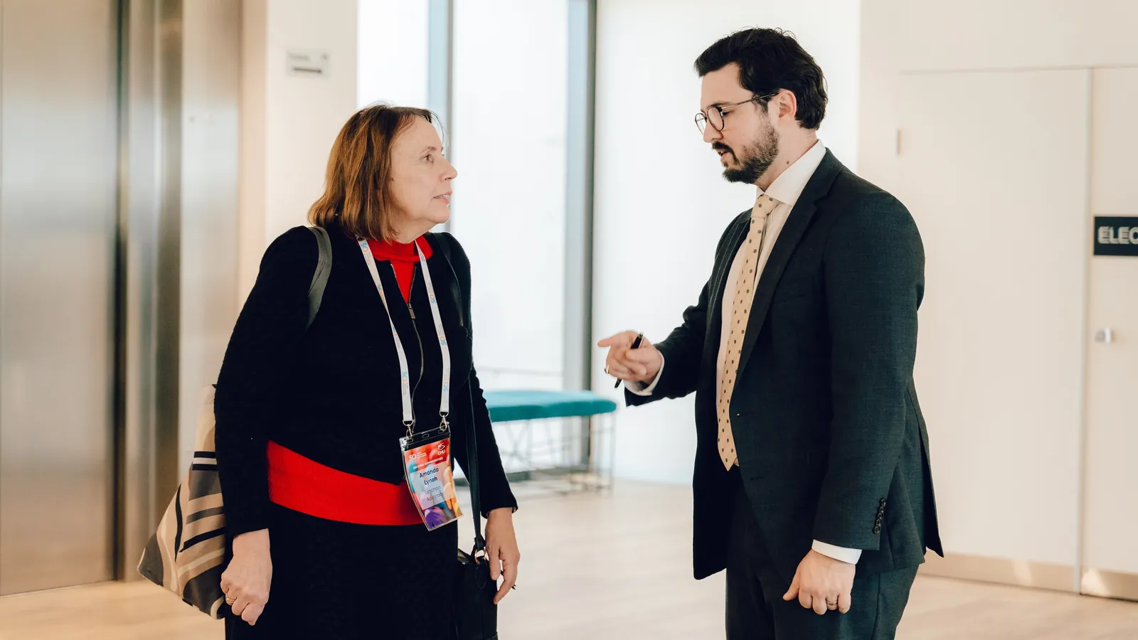 Joshua Baldwin in conversation with a colleague at a professional event