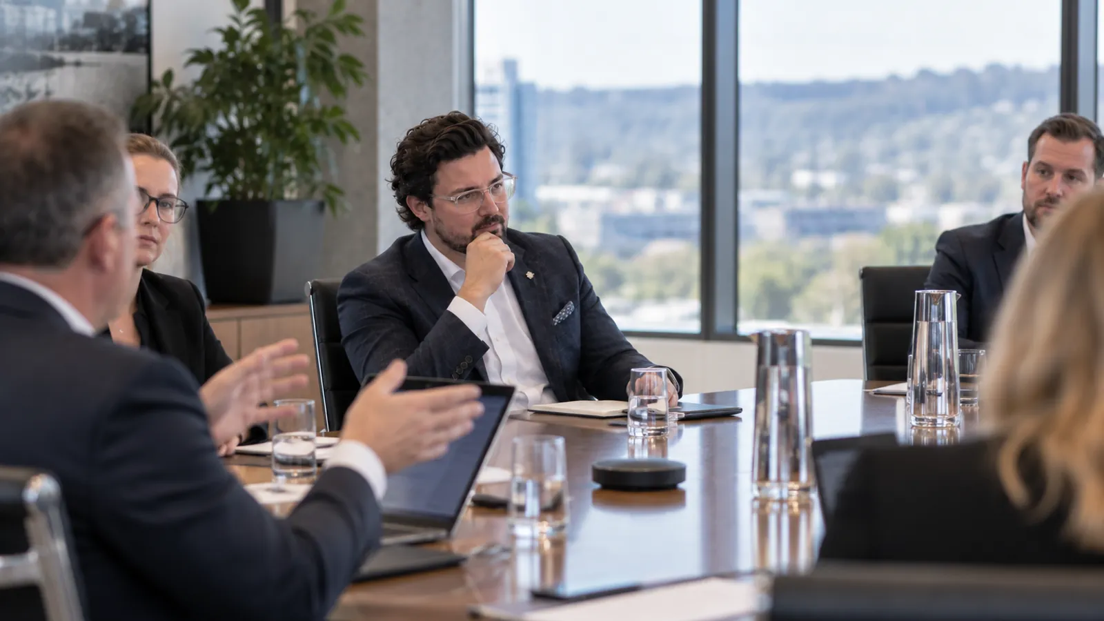 Joshua Baldwin listening during a boardroom meeting